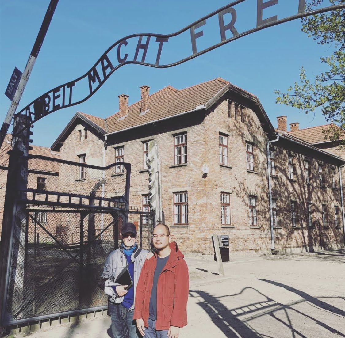 Non standing at the Arbeit Macht Frei gate of Auschwitz